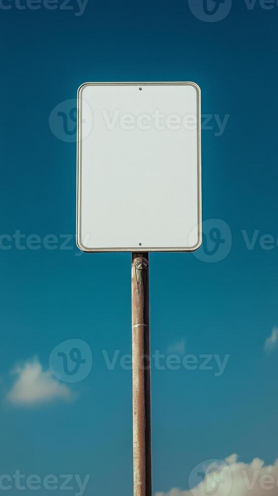 Closeup of a blank rectangular road sign on a tall post, ready for custom text photo
