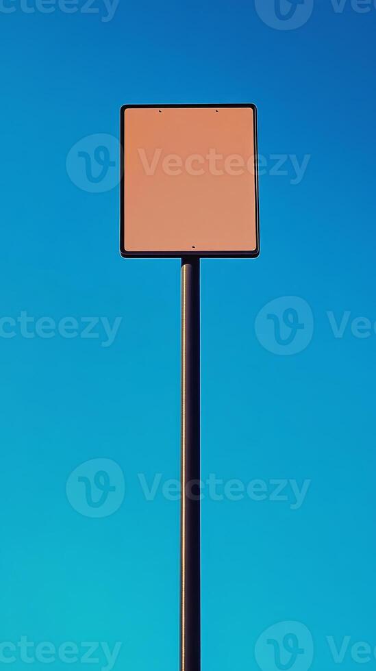 A tall, plain road sign standing against a bright blue sky, no text photo