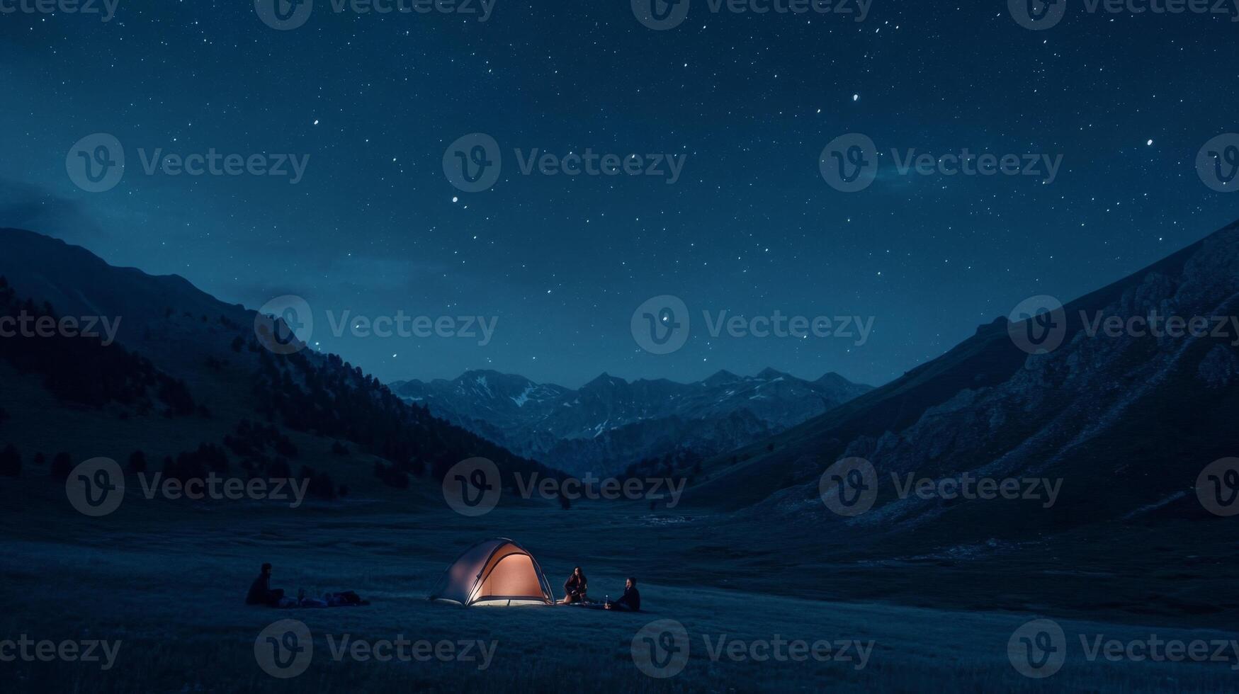 A group of friends camping under the stars in a remote mountain area photo