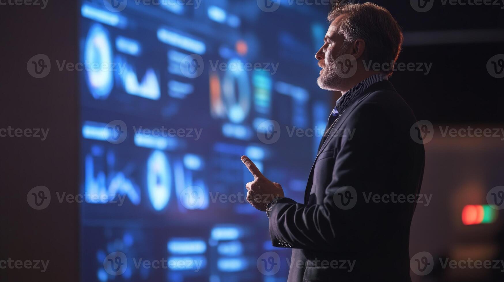 A keynote speaker presenting in front of a large screen with visual aids photo