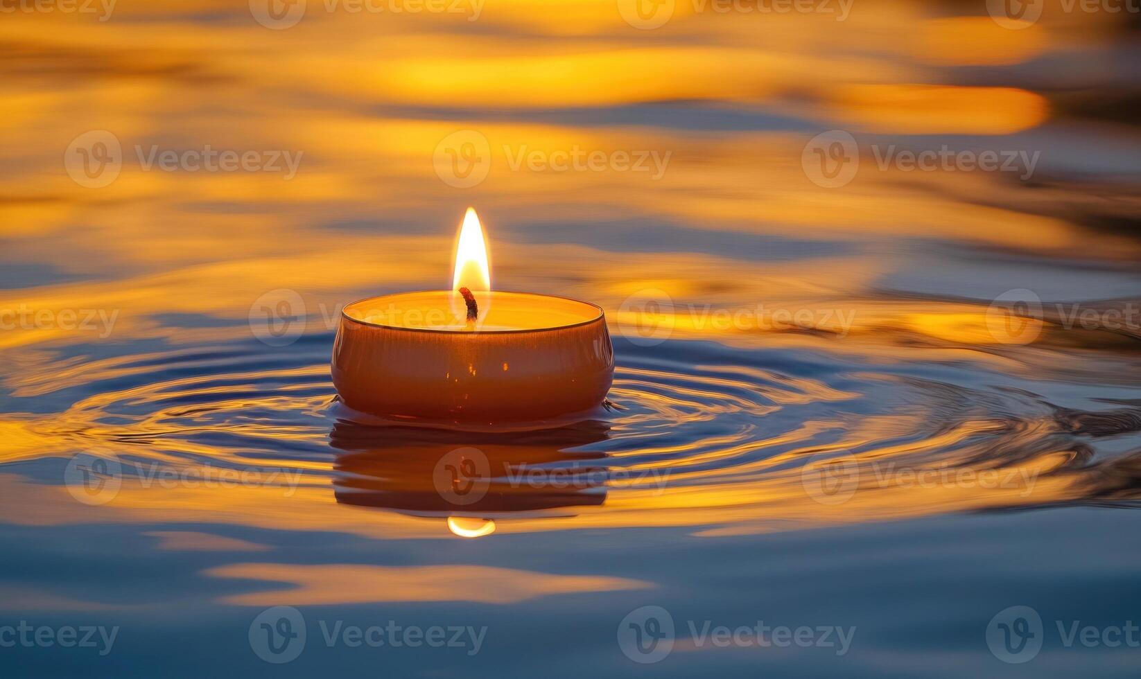 Close-up of a single candle with a flickering flame, floating on calm water photo