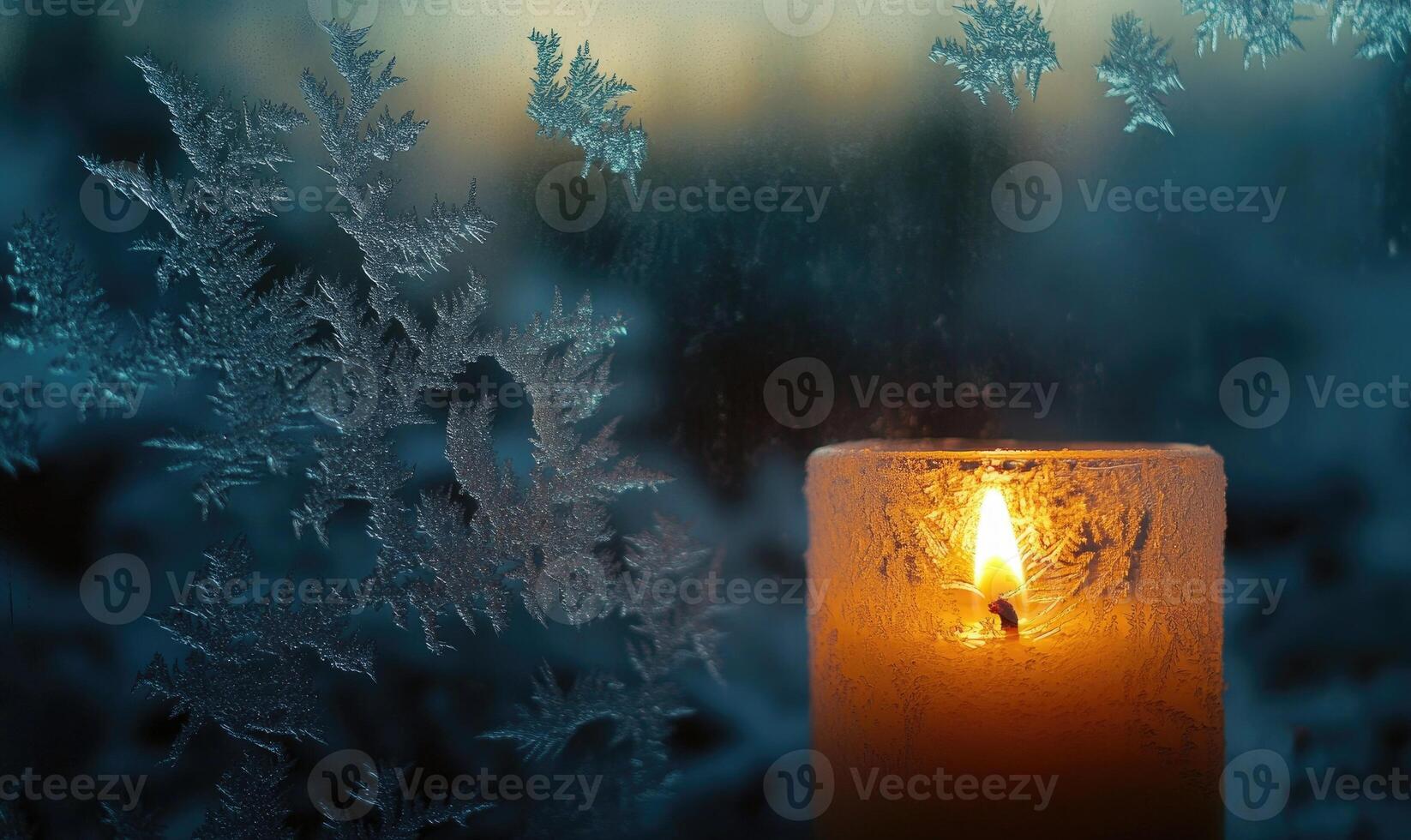 A candle is lit in front of a frosted window photo