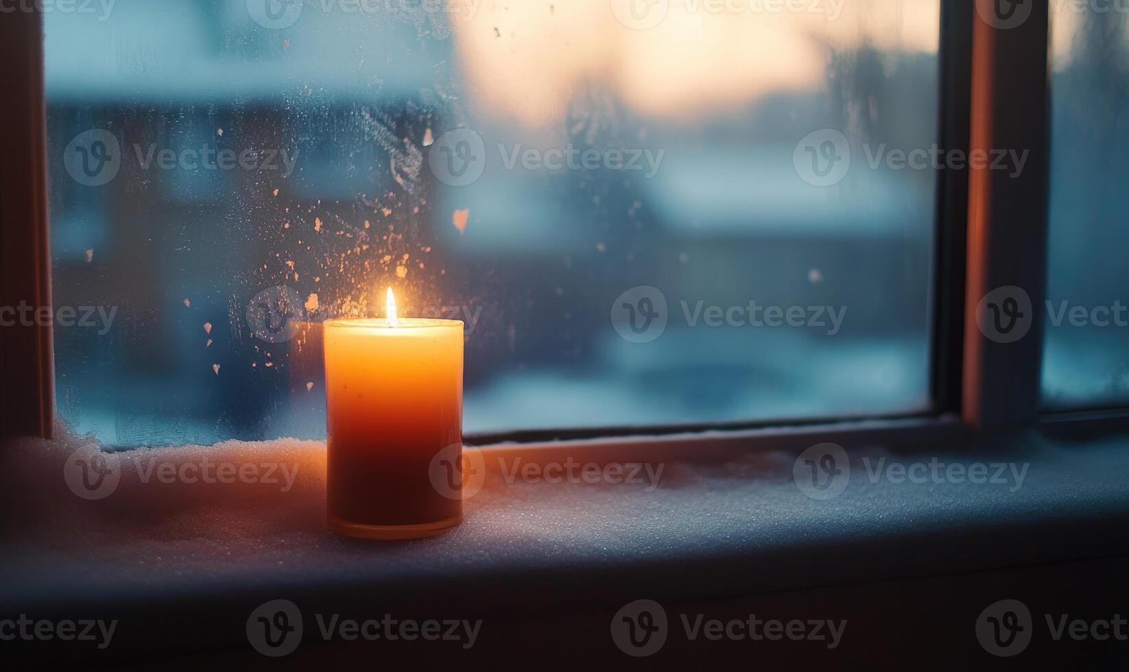 A candle is lit in a window, creating a warm and cozy atmosphere photo