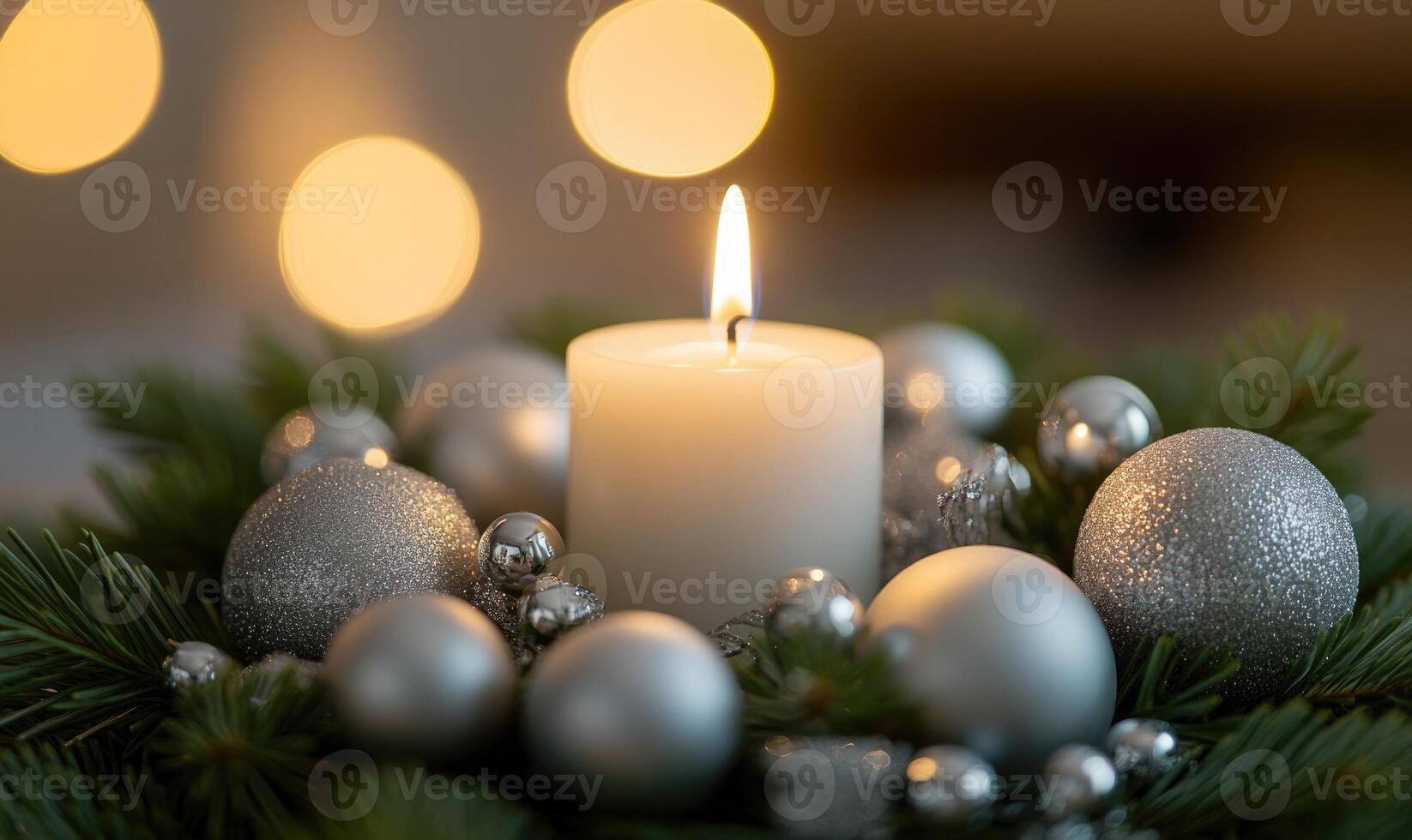 A candle is lit in a wreath of Christmas ornaments photo