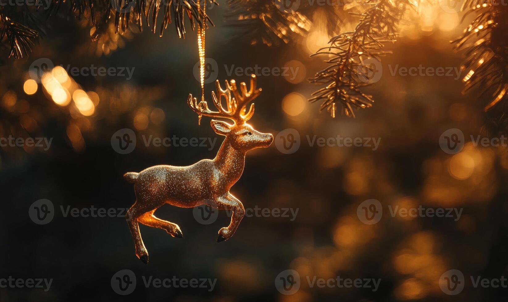 A gold deer ornament hanging from a tree branch photo