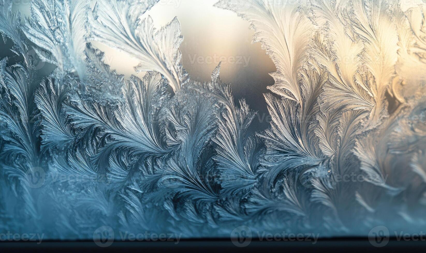 A frosty window with intricate designs of ice crystals photo