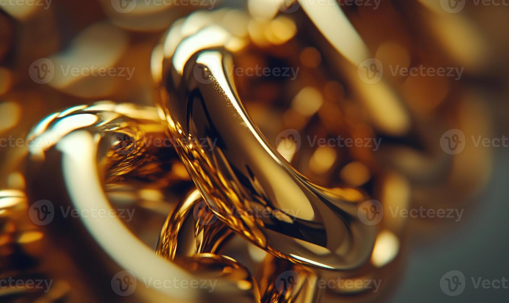 A close up of gold chain links with a shiny, reflective surface photo
