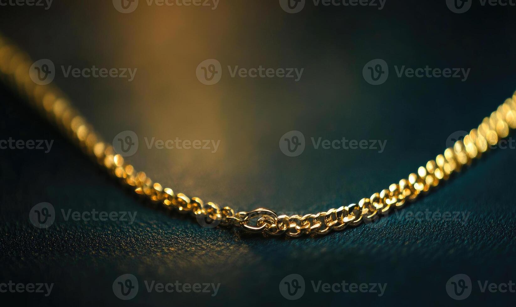 A gold chain necklace with a clasp is shown on a dark surface photo