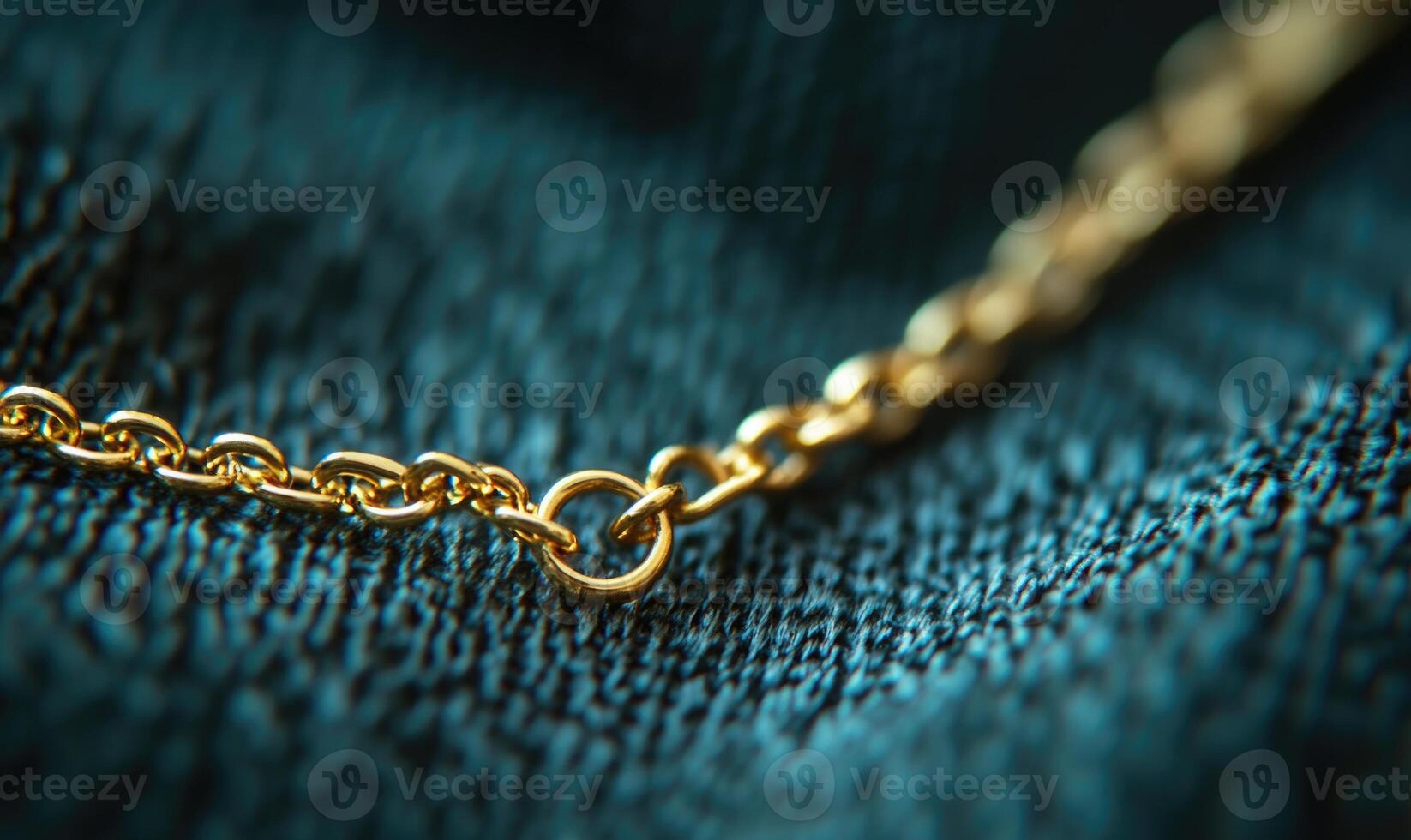 A gold chain with a gold clasp is shown on a blue background photo
