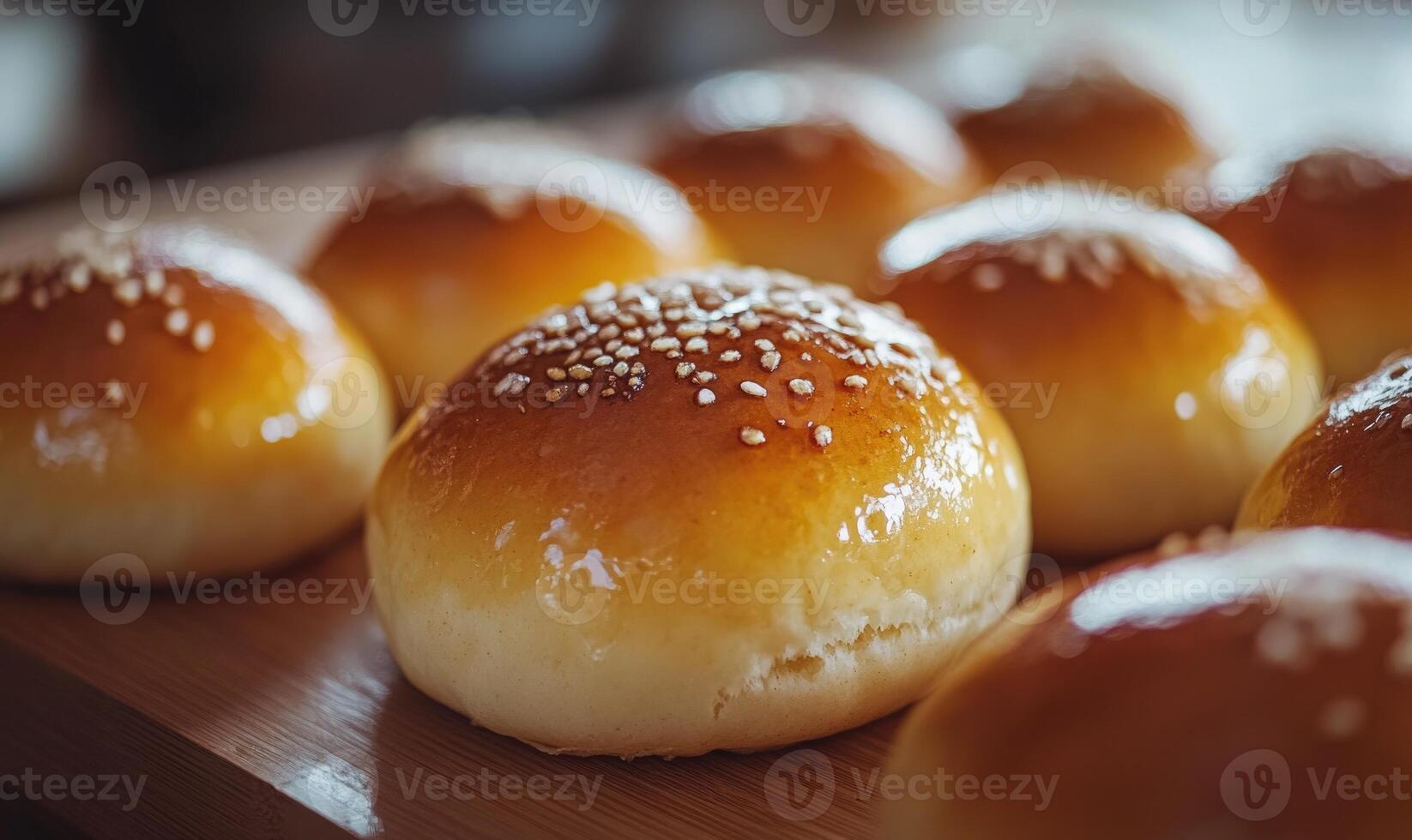 A close up of a dozen sesame seed buns photo