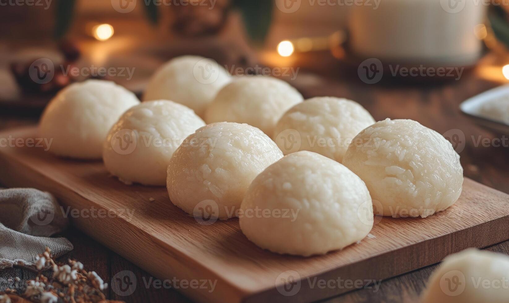 A wooden board with a bunch of rice balls on it photo