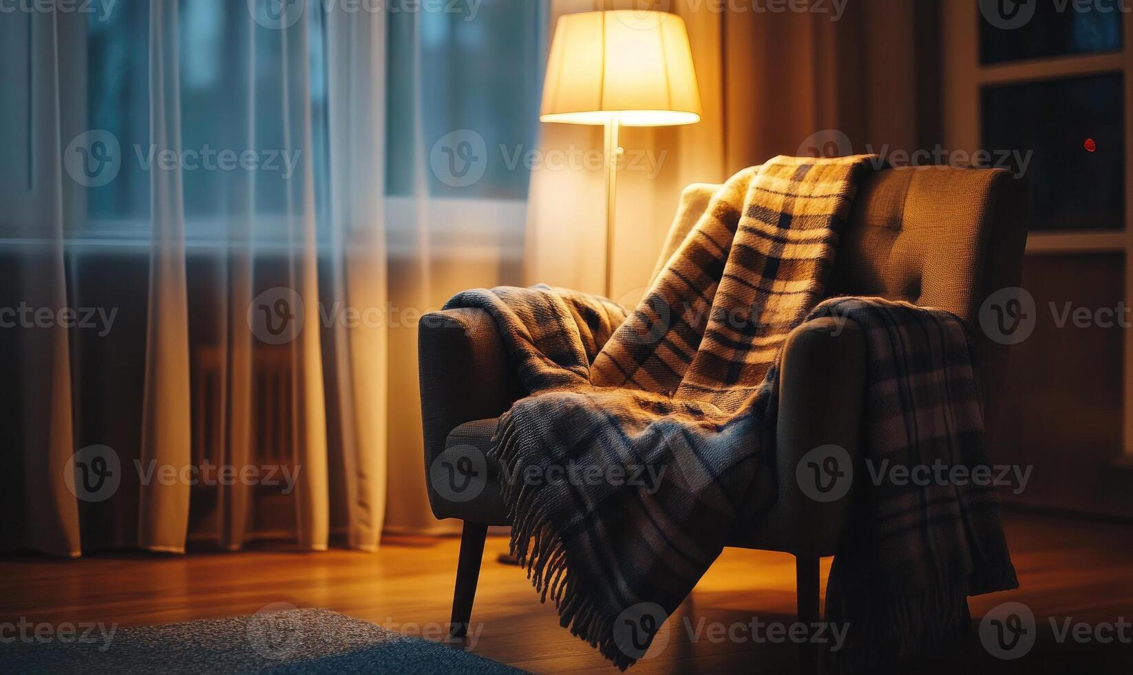 A chair with a blanket draped over it and a lamp in front of it photo