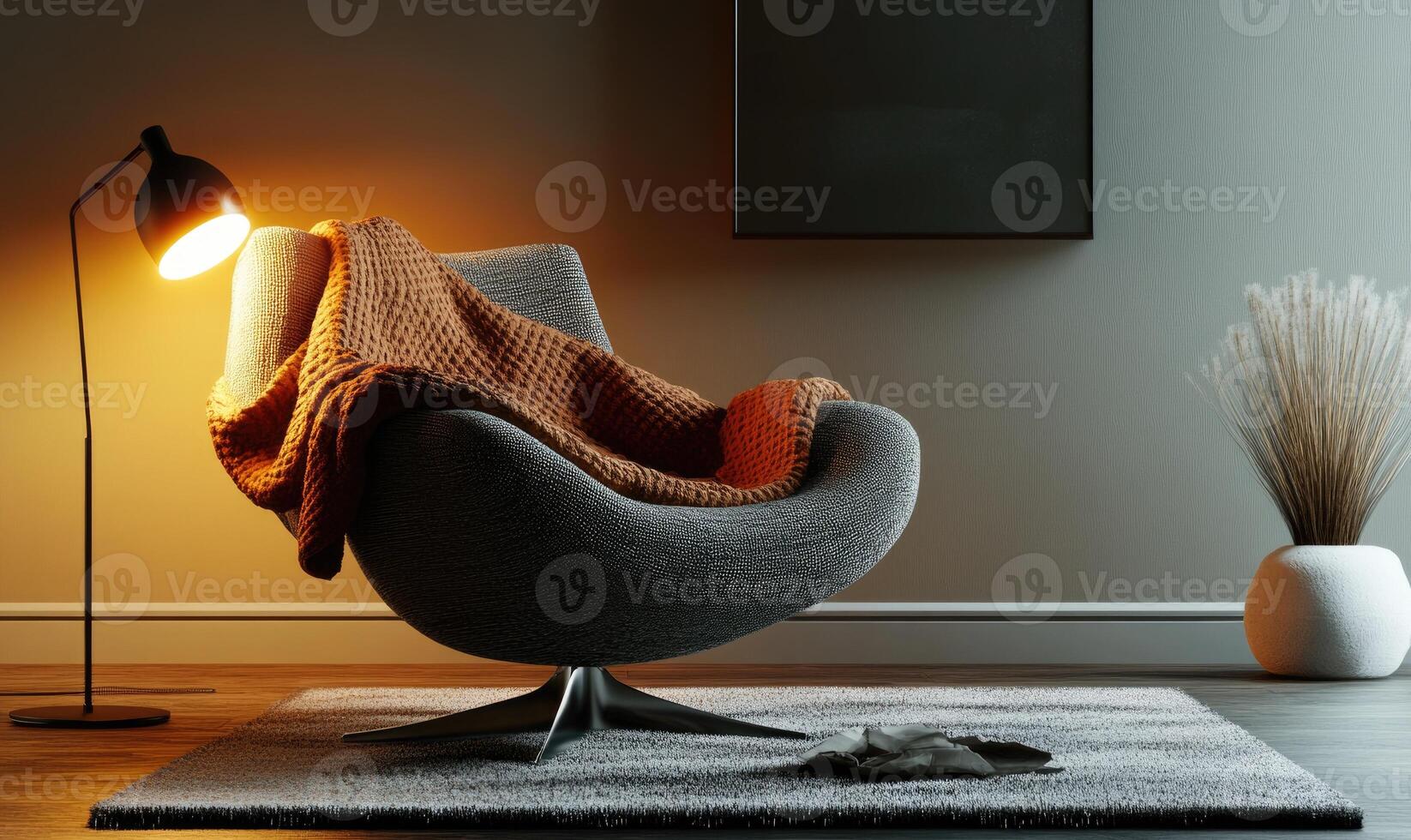 A chair with a blanket draped over it sits in a room with a lamp on a table photo
