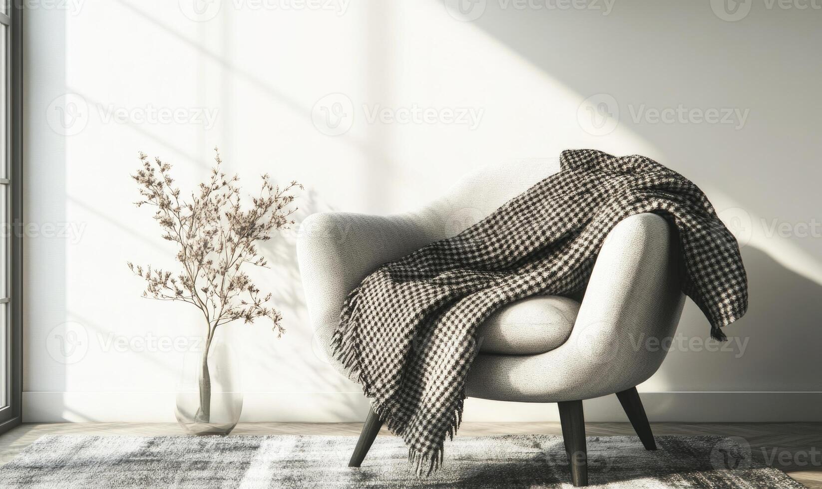 A white chair with a black and white checkered blanket draped over it photo