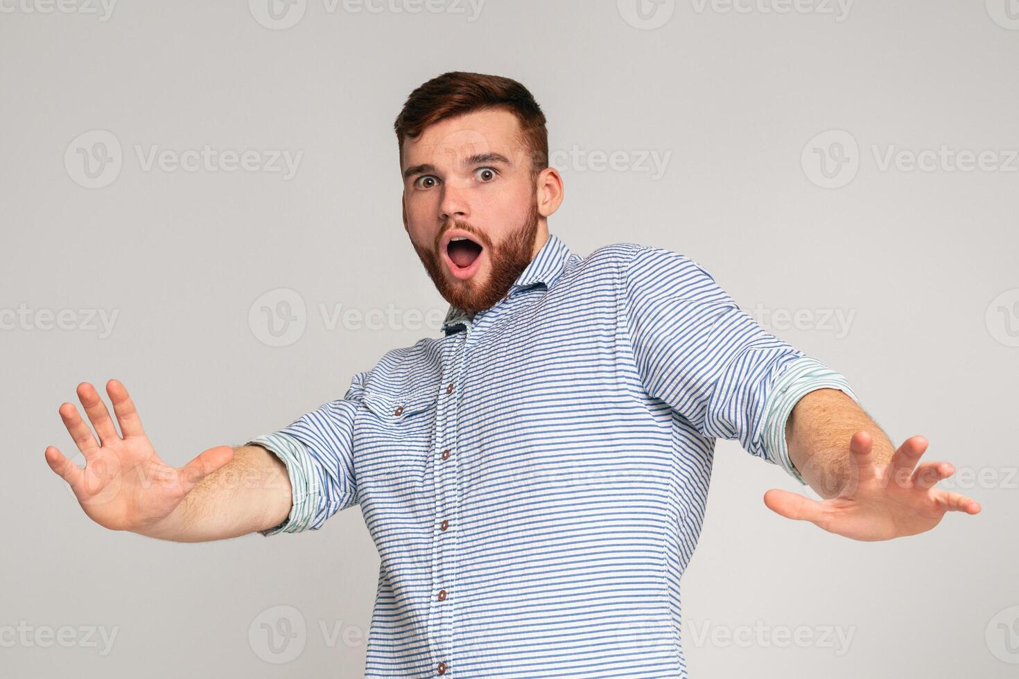 I am afraid. Portrait of scared man with open mouth on studio background, panorama, copy space photo