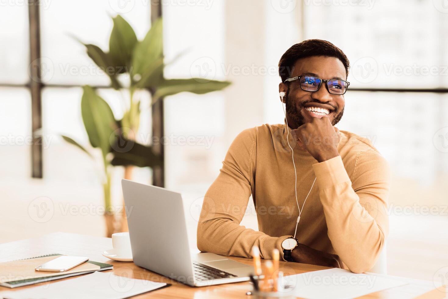 Break At Work. Happy african manager listening to music at work wearing headphones. Free space photo
