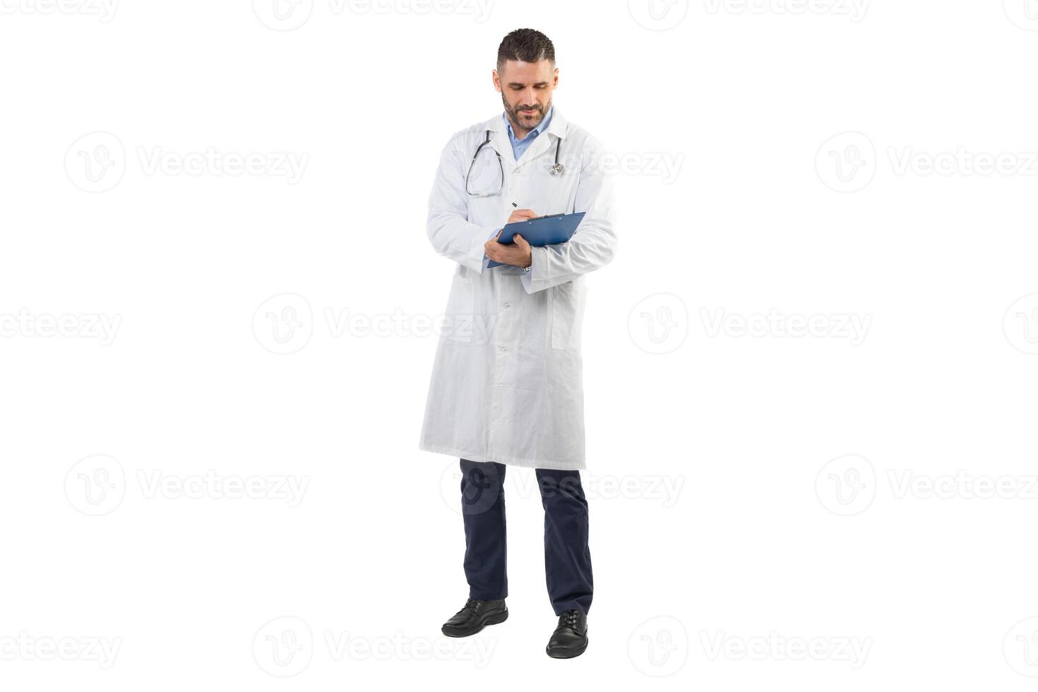 A man doctor, dressed in a white coat, stands against a white background while writing on a blue clipboard. He appears focused on his task, indicating a commitment to his medical duties. photo