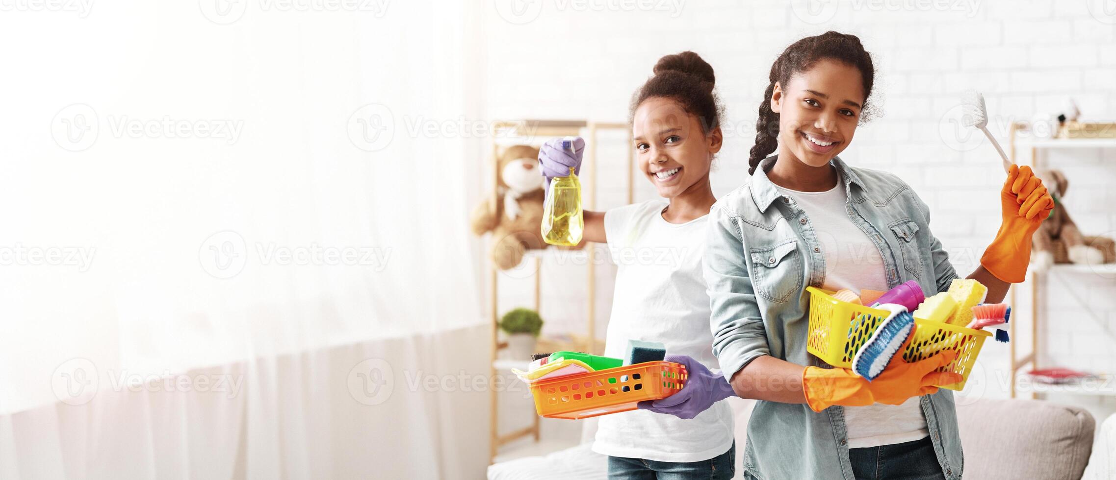 Cleaning concept. Cheerful black girl with cleaning tools ready to clean home, helping their parents, copy space photo