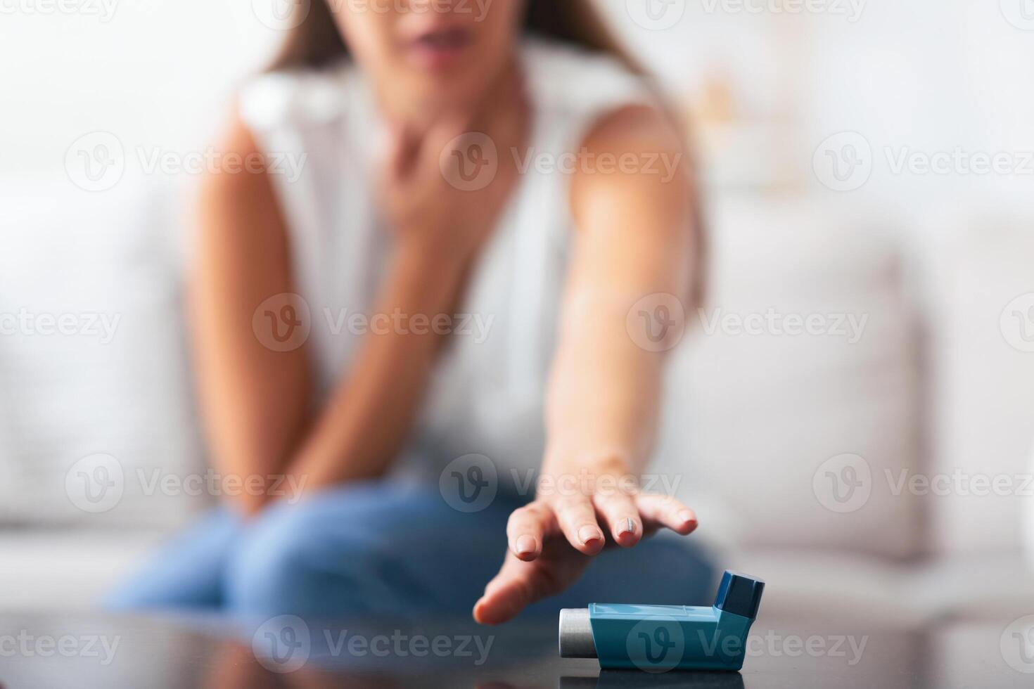 Respiratory Depression. Unrecognizable Woman Reaching For Asthma Inhaler Preventing Attack At Home. Selective Focus, Shallow Depth photo
