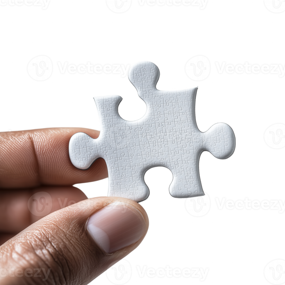 A close-up of a hand holding a single white puzzle piece. The background is isolated and plain, highlighting the texture and shape of the piece. png