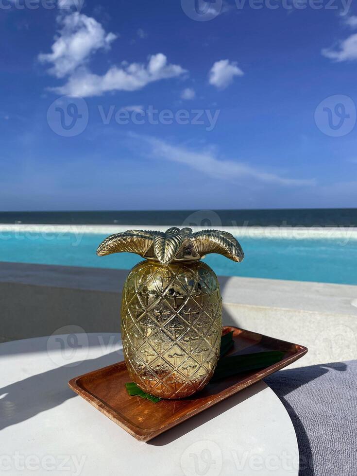 Pineapple juice, a refreshing drink with a sea view. photo