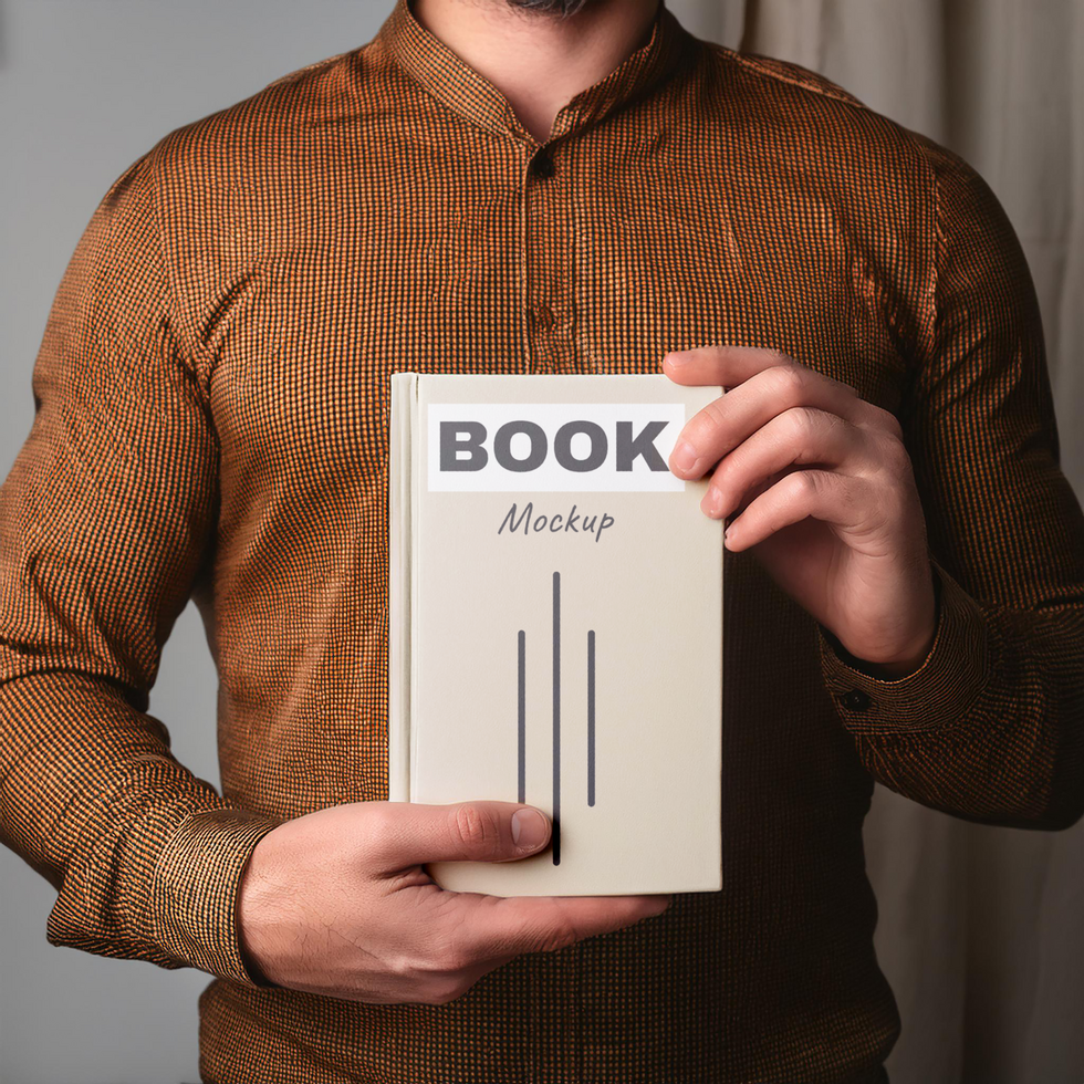 Man holding book mockup psd