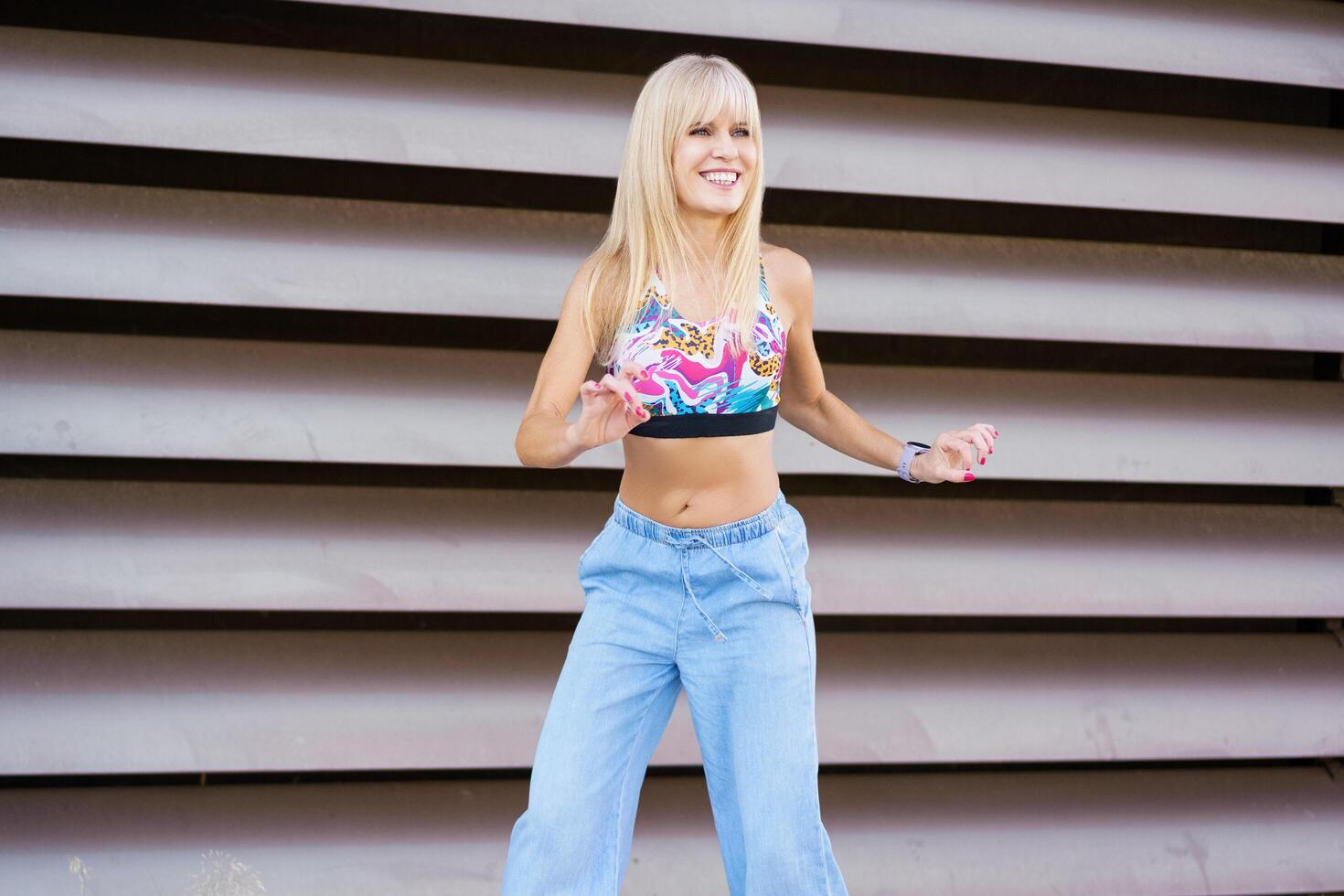 Happy dancer performing choreography in the city photo