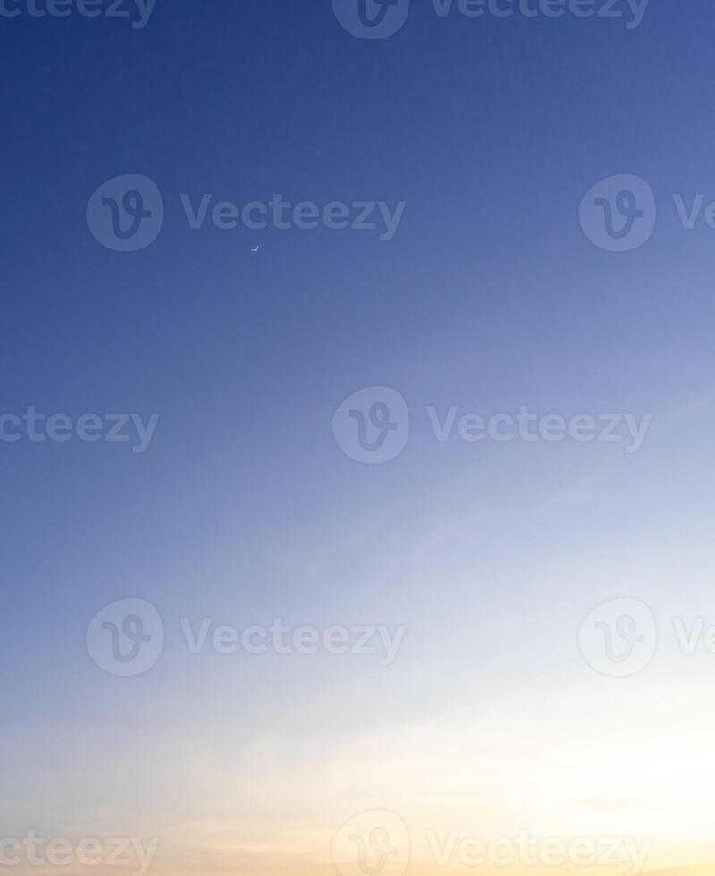 Beautiful morning or evening blue and orange sky while sunsets or sunrises taken at the sea used as natural blackground texture photo