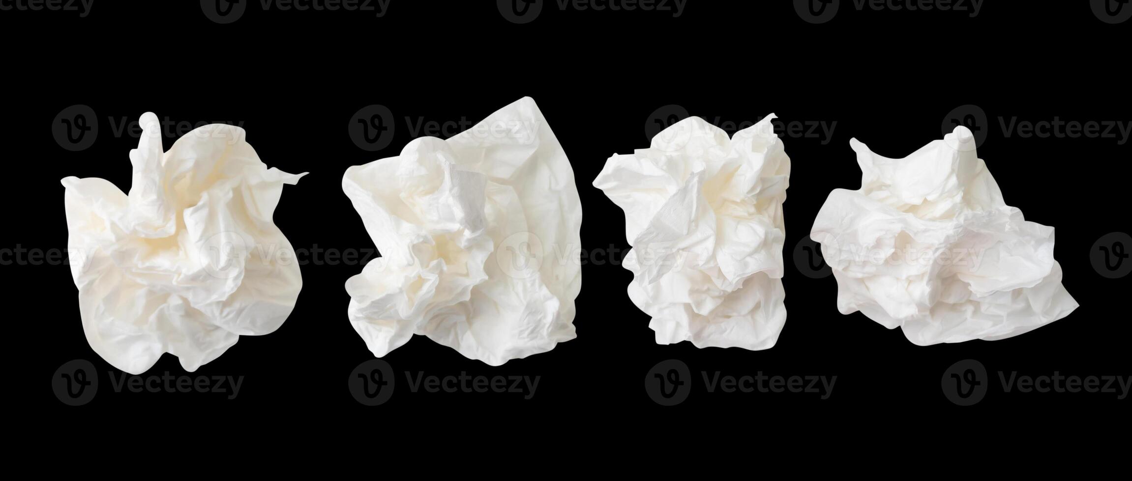Top view set of screwed or crumpled white tissue paper ball isolated on black background with clipping path photo