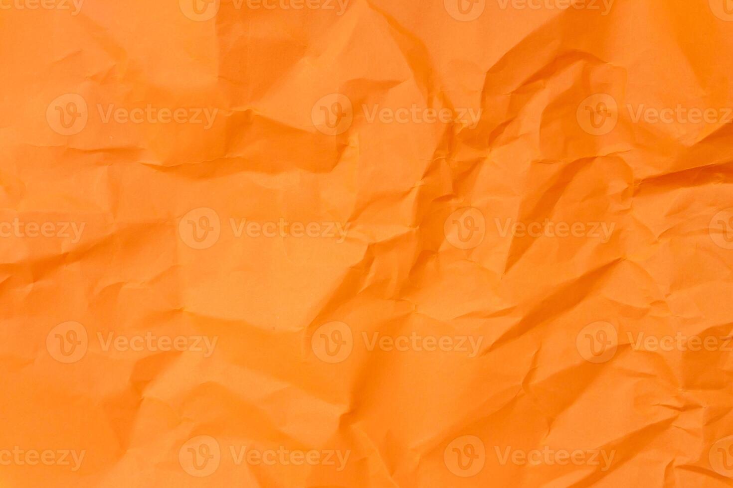Top view and full frame of wrinkled or crumpled orange paper texture used as crumpled paper background texture in decorative art work. photo