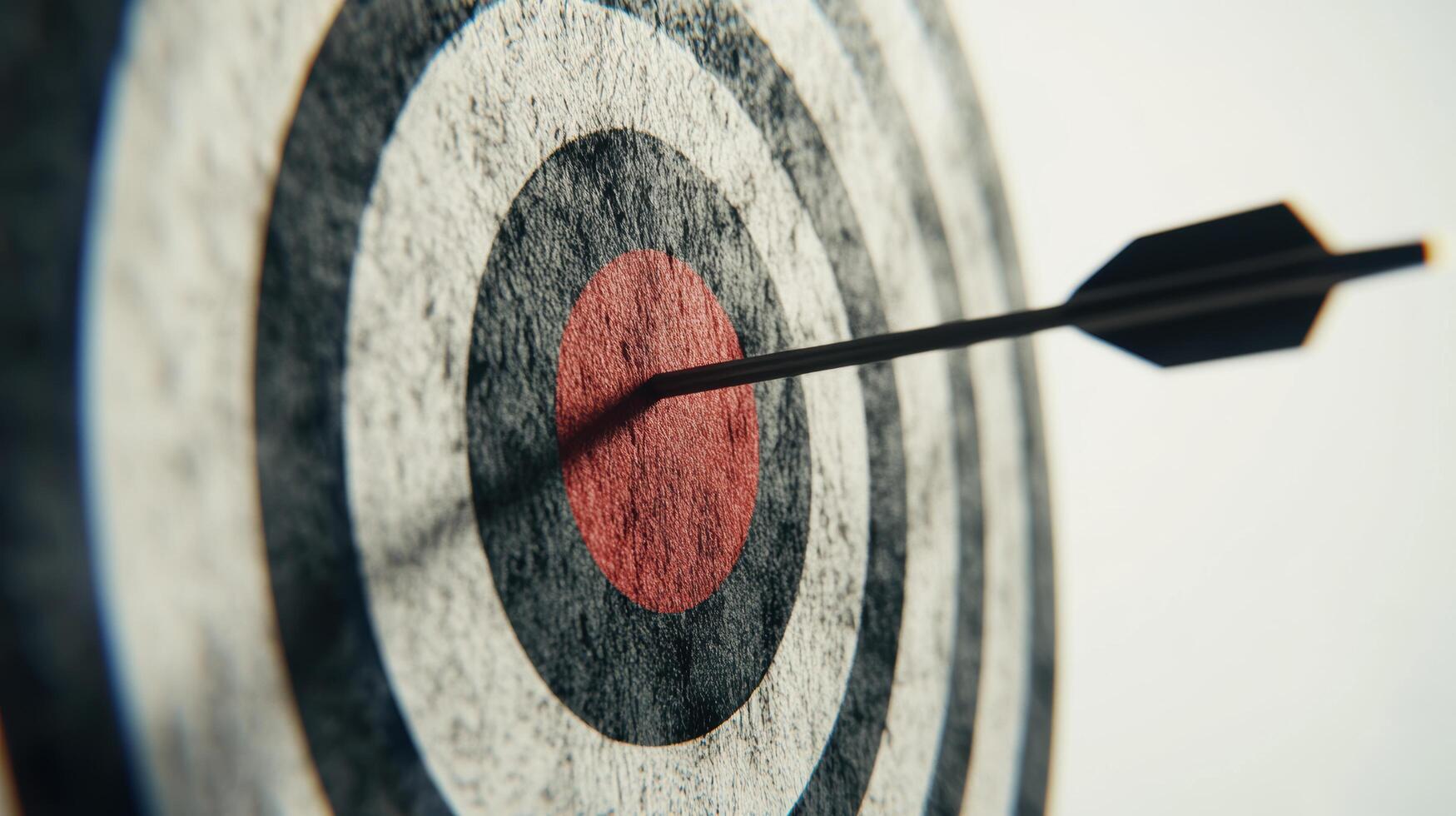 A dart is hitting the center of a target photo