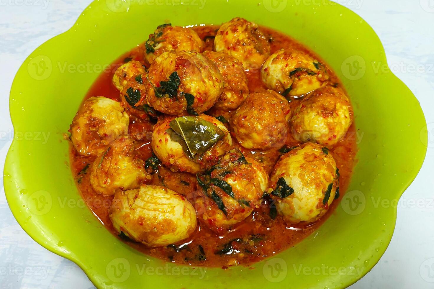 Balado round eggs are plated on the dining table photo