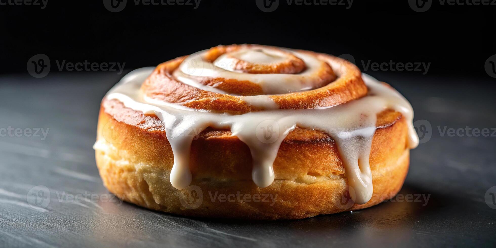 Delicious cinnamon roll with icing on dark background photo