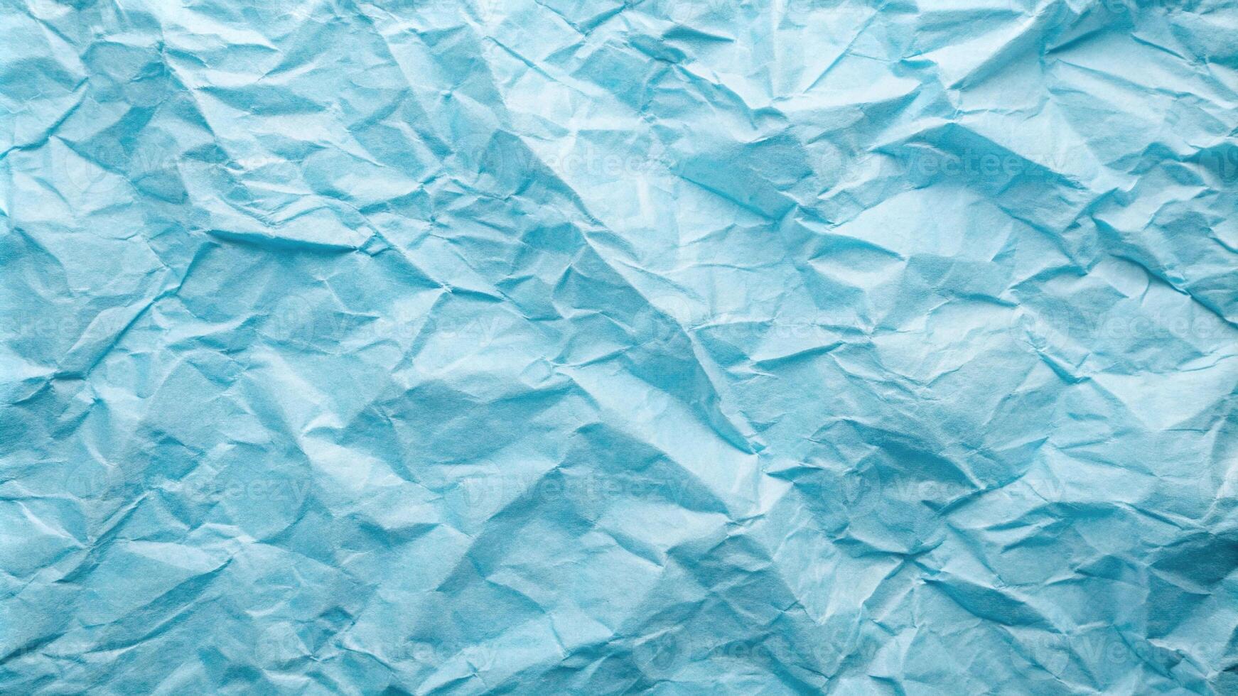 Crumpled kraft paper with light blue hue texture at an angle photo