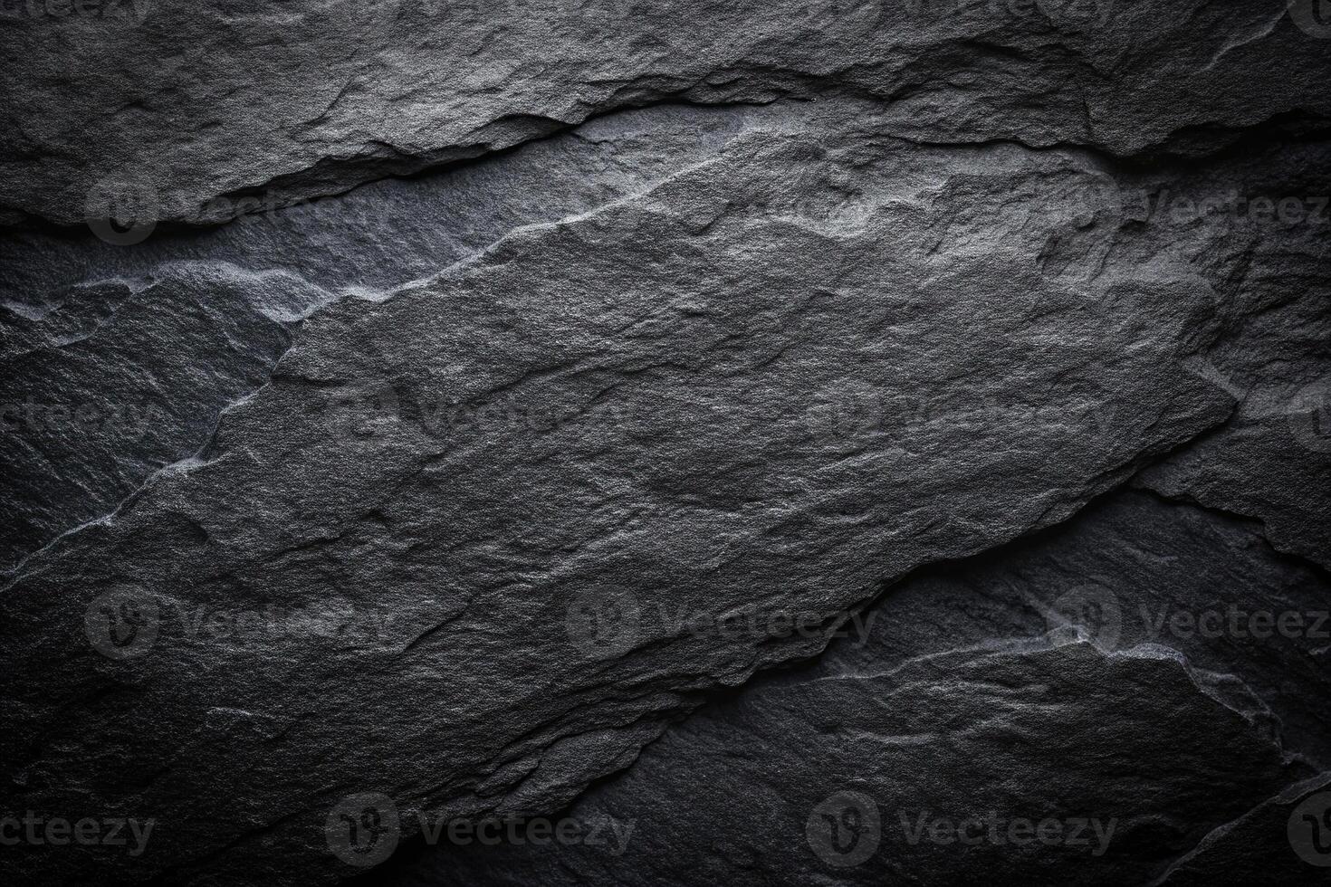 Dark black textured abstract background resembling rock or stone photo