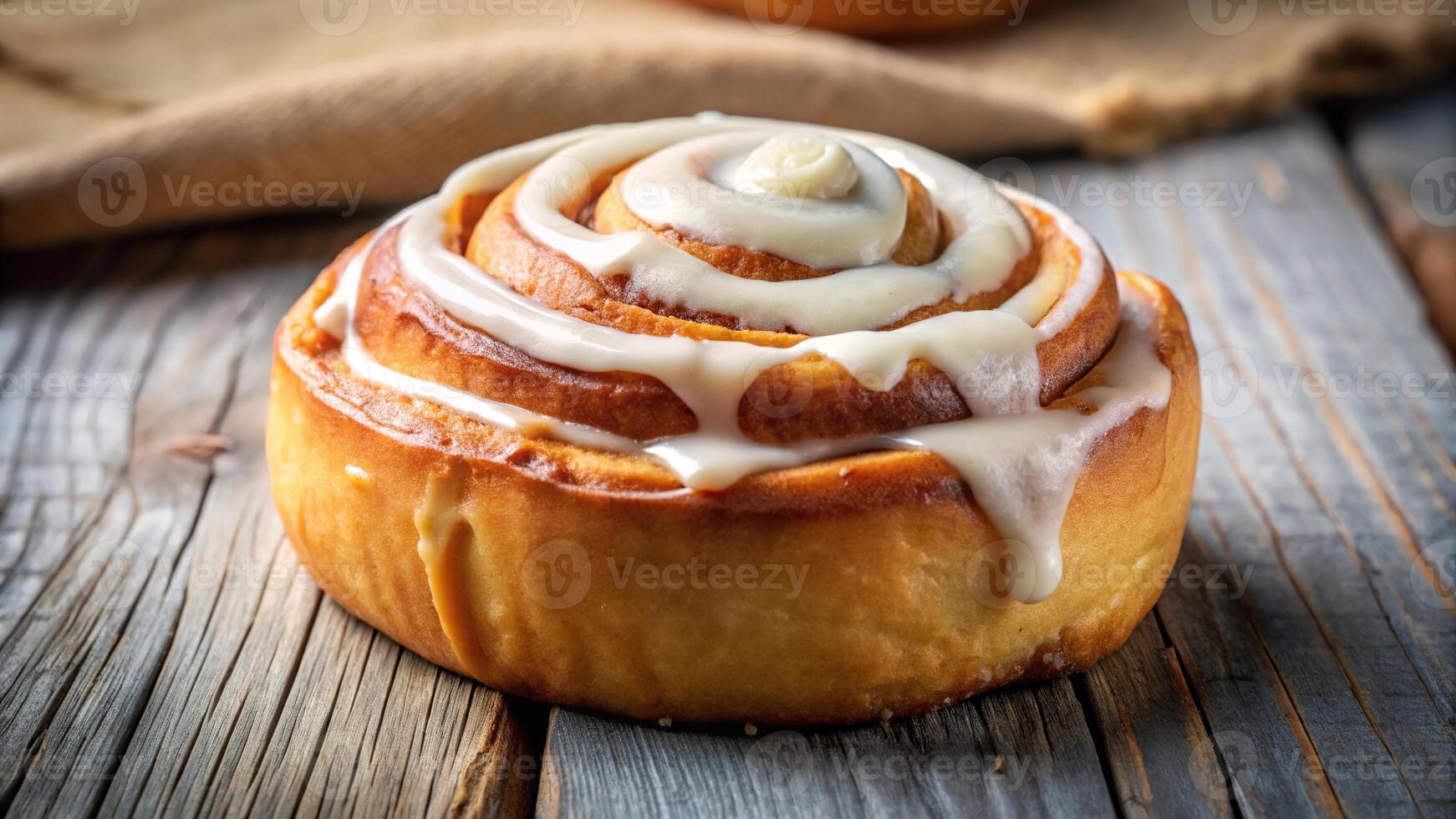 Delicious cinnamon roll with icing on top photo