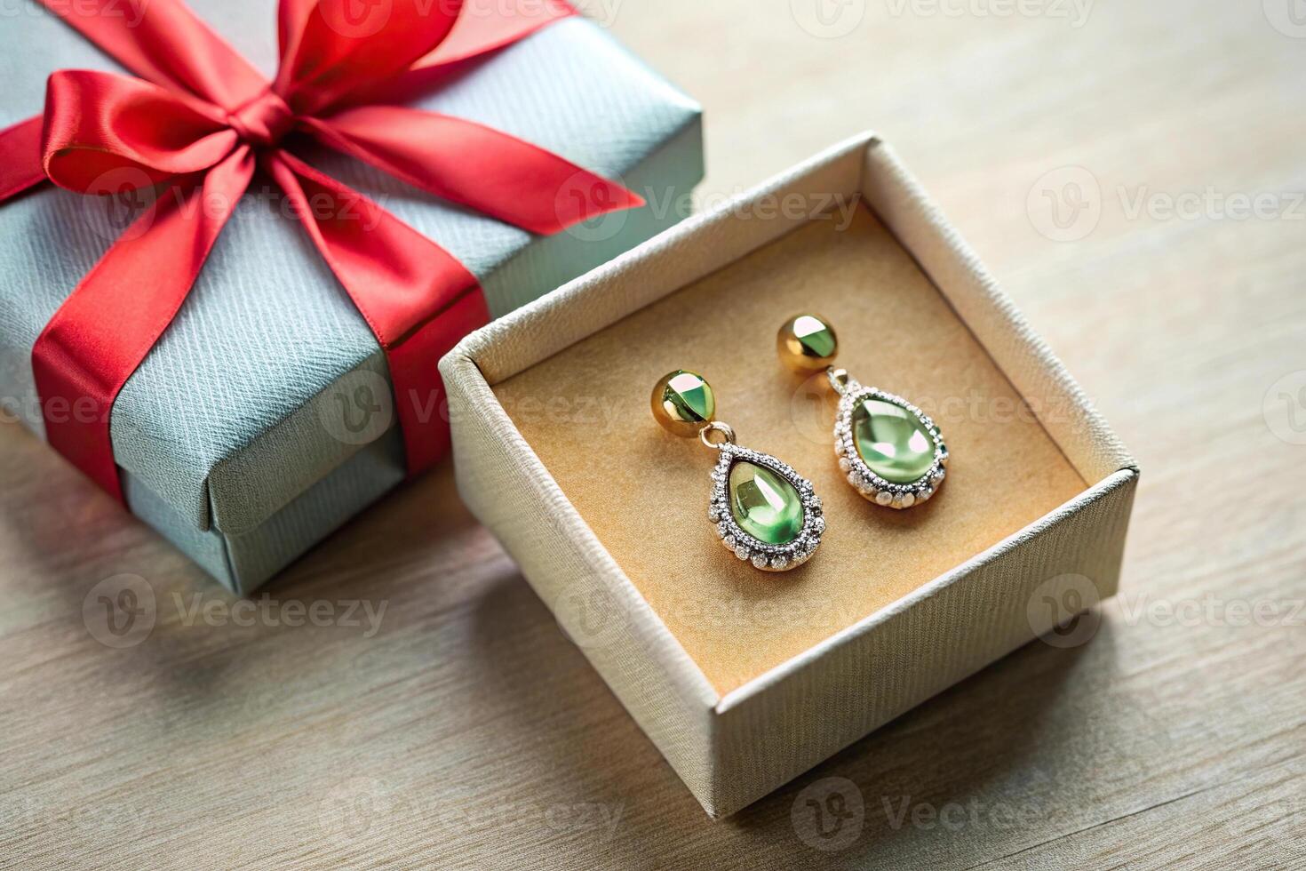 Earrings with stone on gift box with ribbons photo