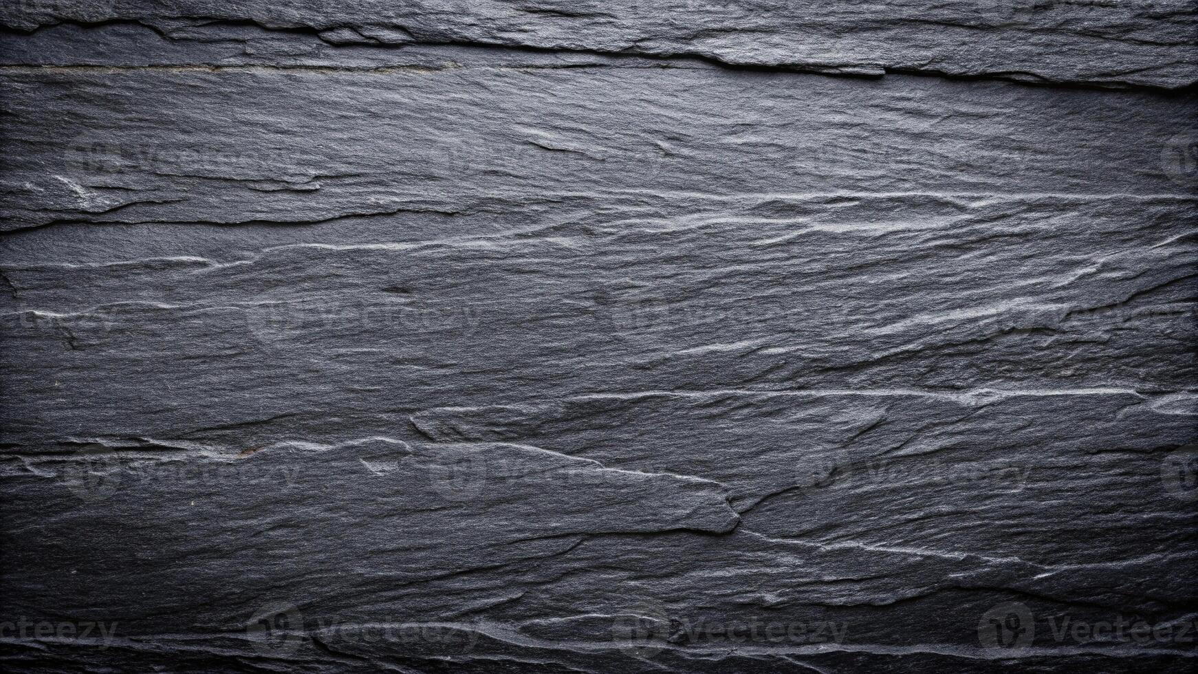Dark grey black slate stone background or texture with leading lines photo