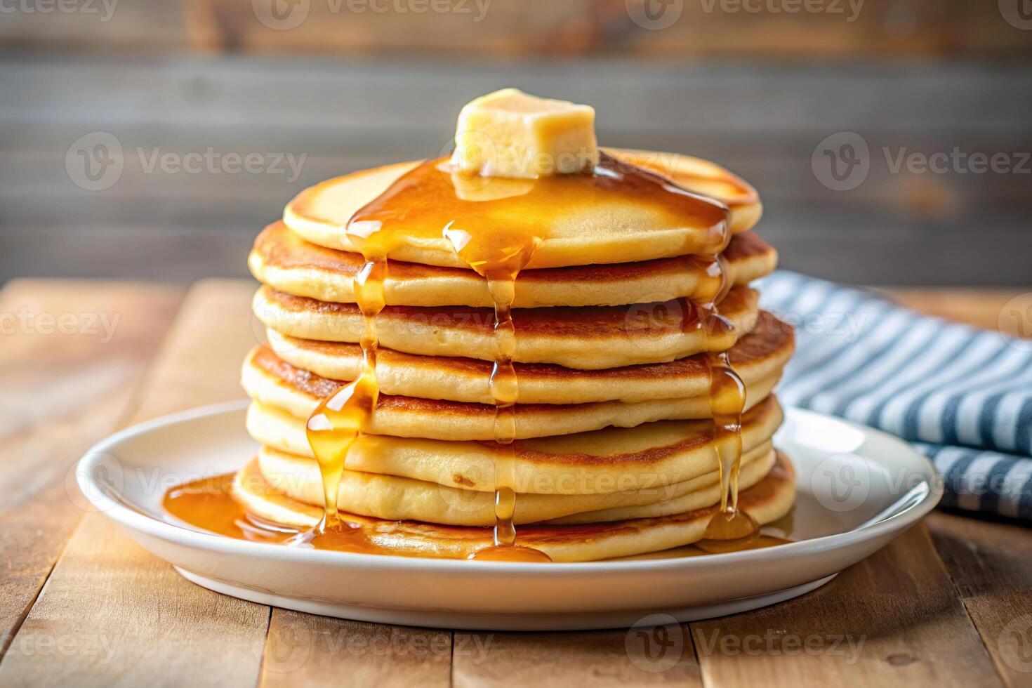 Delicious stack of pancakes with butter and syrup photo