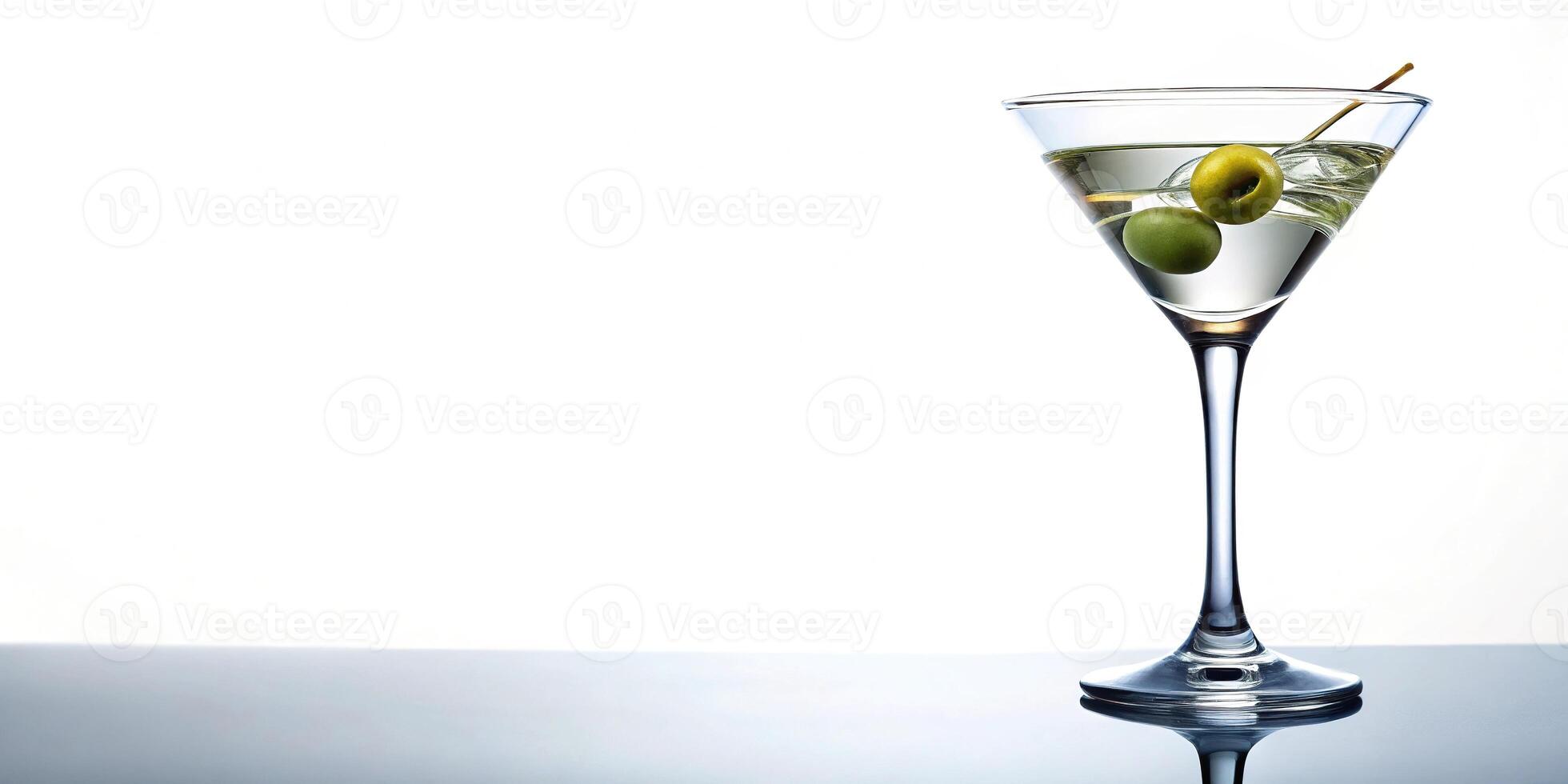 Low angle view of dry martini cocktail with olive in isolated glass on white background photo