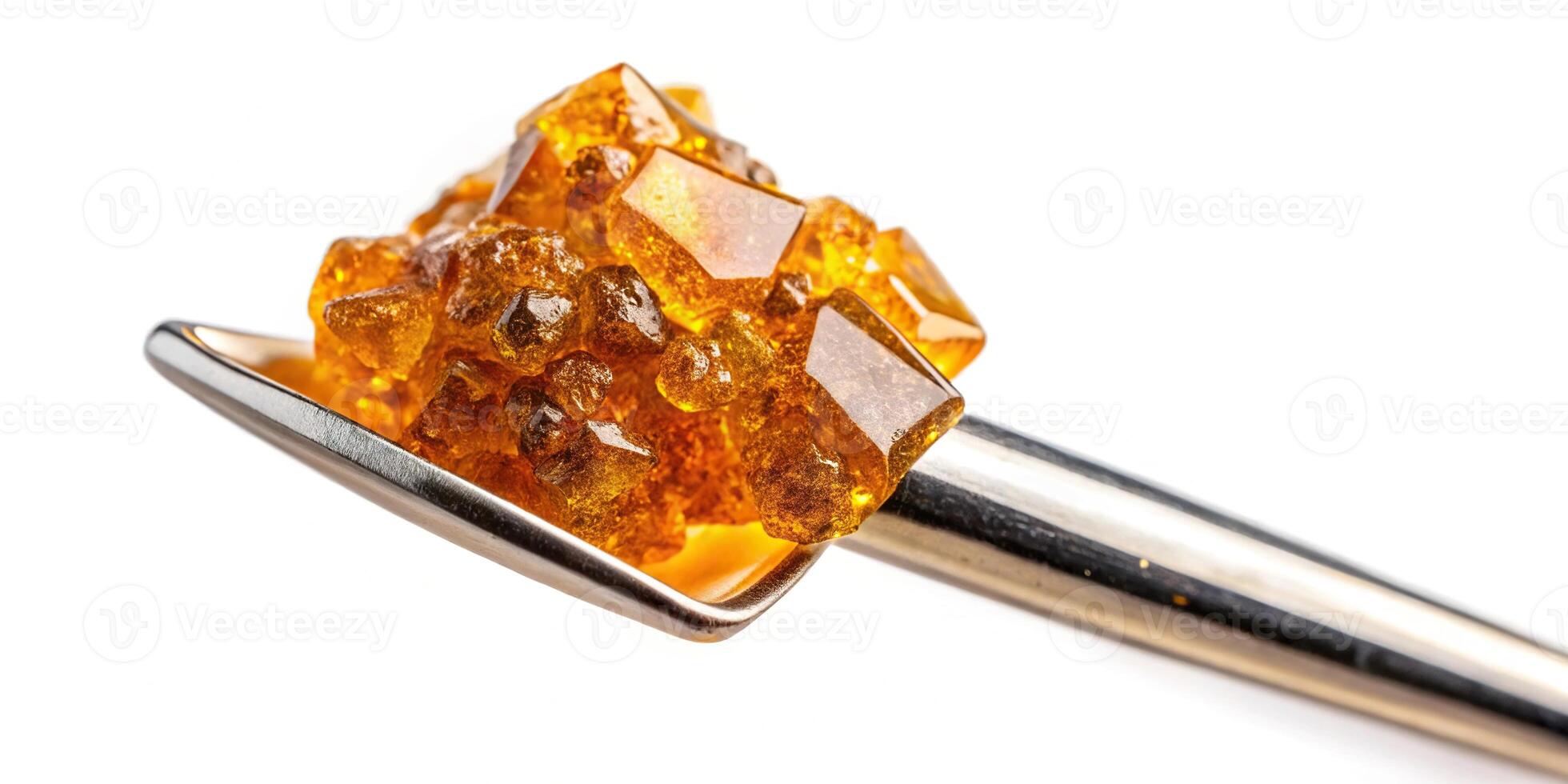 live resin diamonds on gold titanium dab tool with white background photo
