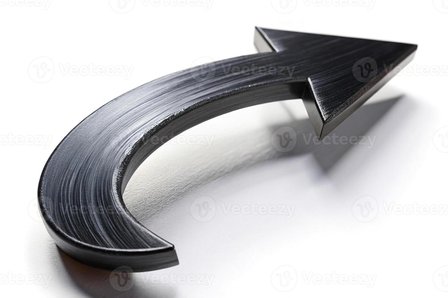 Painted black arrow on white background with shallow depth of field photo
