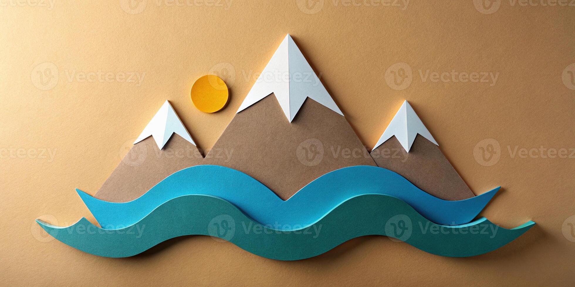 Paper cutout of mountain range with wave and sun in background photo