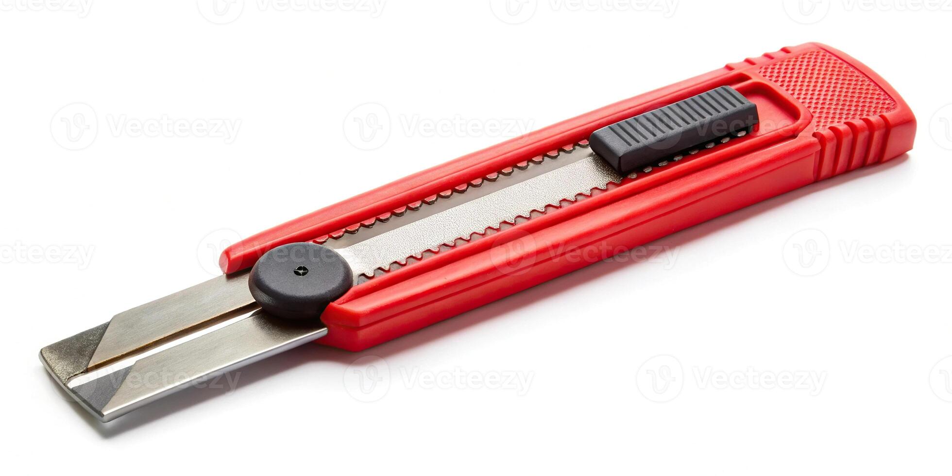 Red stationery knife with a blade isolated on a white background Low Angle photo