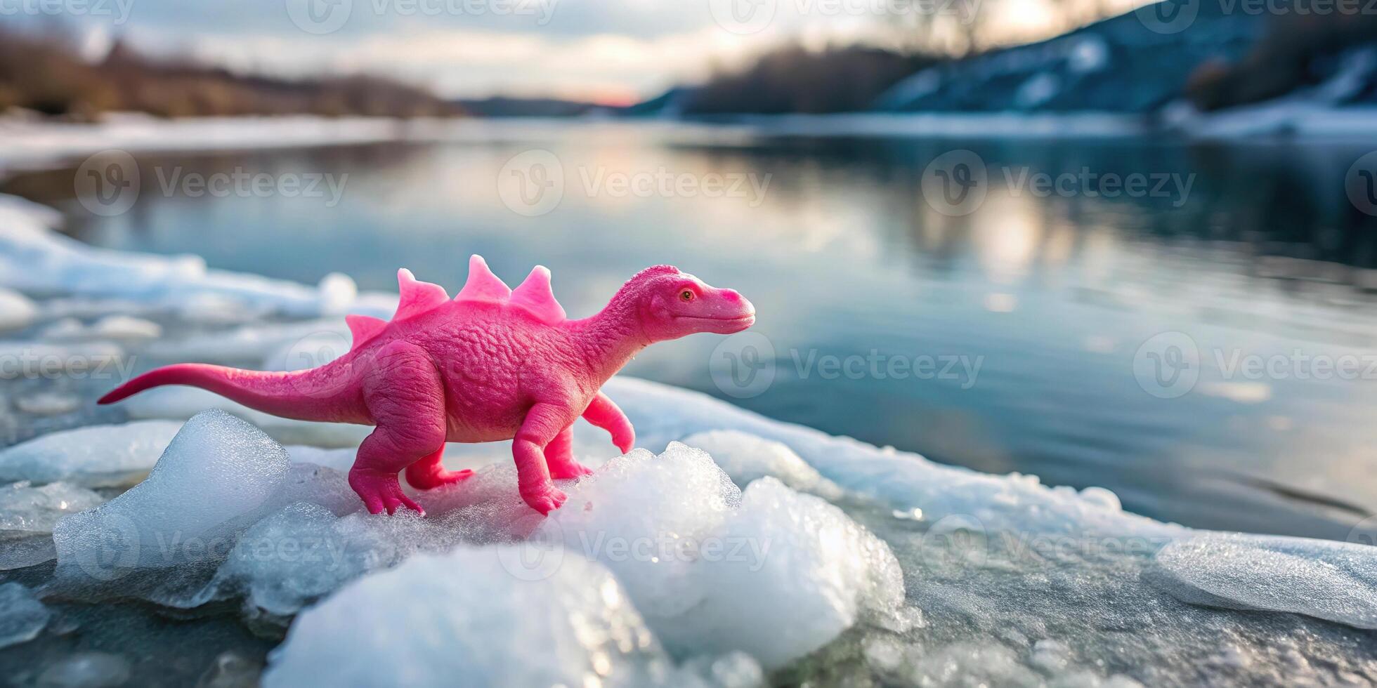 Pink toy dinosaur on riverside with ice floes High Angle photo
