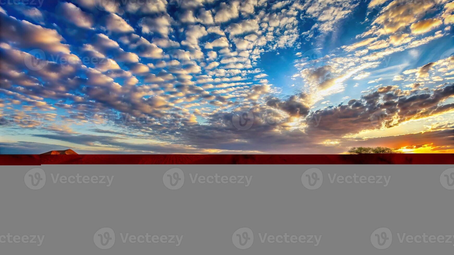 Panoramic view over Namibian Kalahari desert at sunset, blue sky, light clouds photo