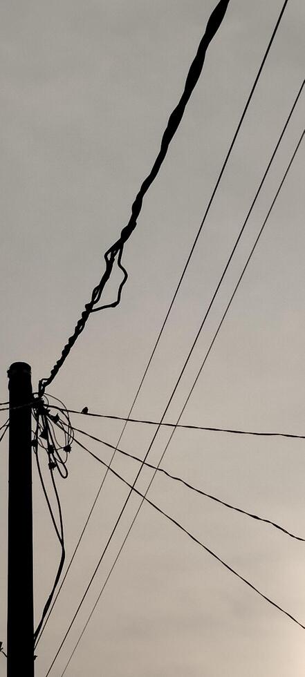 A black and white photo of wires and power lines