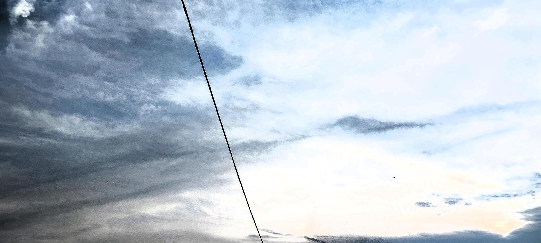 A kite flying in the sky with a cloudy sky photo