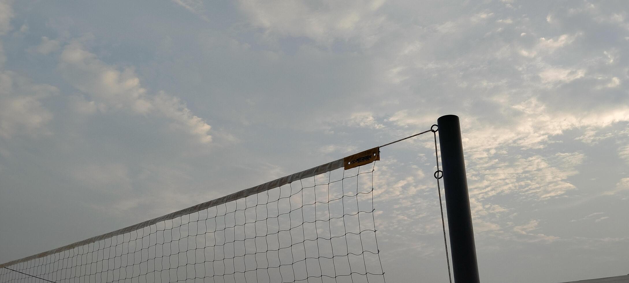 A volleyball net is in the air photo