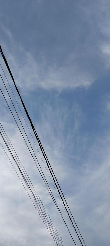 A street sign with a red and white kite flying in the sky photo